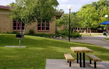 picnic table in front of Kenny Rec Center during summer