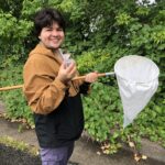 person with insect net by Grass Lake Wetland