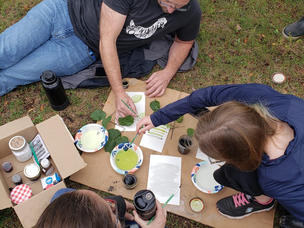 People painting with buckthorn ink